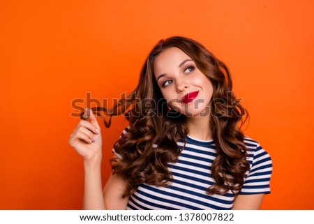 Close up photo beautiful she her lady red lipstick hold play arms curl look up empty space imaginary flight overjoyed wear casual striped white blue t-shirt clothes isolated orange bright background