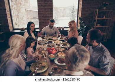 Close Up Photo Big Large Family Thanksgiving Conversation Members Company Brother Sister Granny Mom Dad Grandpa Son Daughter Sitting Round Festive Holiday Full Tasty Dishes Table Loft House Indoors