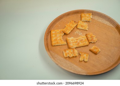 Close Up Photo Of Biscuit Cracker Over The Wooden Plate, Fork And Spoon, With White Back Ground. That Photos Is Perfect For Food Pamphlet, Product Poster, Product Promotion And Ads.