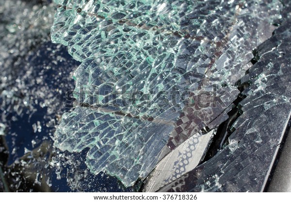 Close up photo of a\
broken windshield