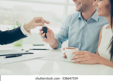 Close Up Photo Of Broker Giving Keys Of New House To Happy Couple.