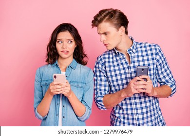 Close up photo of busy with telephones friends she he him his lady guy reading her mail do not let gossiping wearing casual jeans denim plaid shirts isolated on pink background