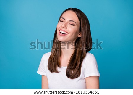 Close up photo of candid excited girl enjoy rejoice joking laughing wear casual style clothes isolated over blue color background