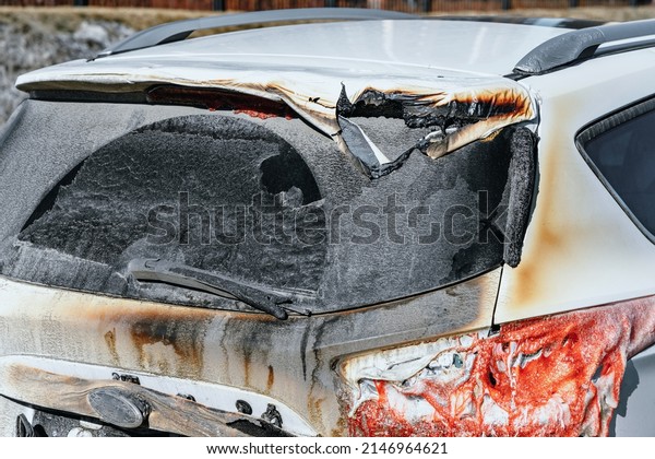 Close up photo of car damaged by\
fire. Plastic automobile parts melted, car\'s paint has\
deteriorated. Arson of a vehicle. Recovery of the burned car by\
insurance.