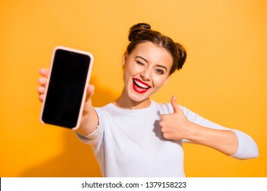 Close up photo of charming beautiful attractive lady taking photo offering suggesting advising product raising her thumb up dressed up white sweater isolated over vivid background