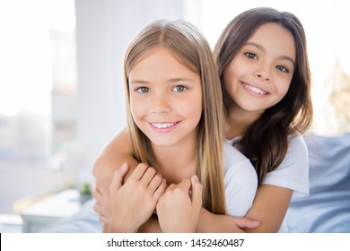 Close Up Photo Of Charming Children Blonde Brunette Hair Have Bonding Feel Satisfied Sit Bed Indoors Room Have Sleepover