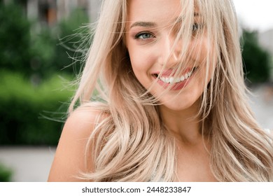 Close up photo of cheerful lovely pretty girl walking in park summer days weekend on blurred backdrop