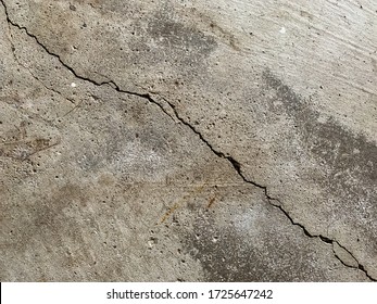 Close Up Photo Of A Crack In A Concrete Floor. Structural Repair And Construction.