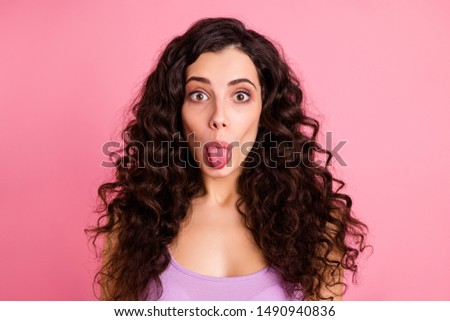 Close up photo of cute charming nice attractive girl showing her tongue to attract you while isolated with pink background