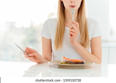 Close up photo of cute teen teenager have lunch dinner feel positive satisfied content hold hand knife silverware say yummy fit body care dressed beautiful trendy clothing sit in apartment