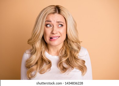 Close Up Photo Of Disappointed Lady Stare Lips Bite Teeth Isolated Over Beige Background