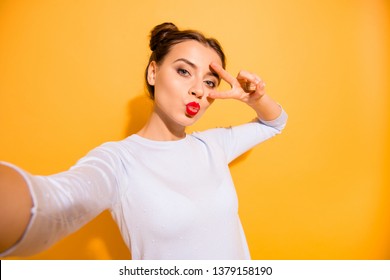Close up photo of fabulous beautiful sensual attractive person people isolated making photo on her cell phone v-sign sharing air kiss internet wearing light woolen clothing on bright background - Shutterstock ID 1379158190