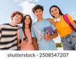 Close up photo of friends teenagers high school pupils college students with bags holding books phone gadgets spending time meeting hanging out outside in skate green nature park looking at camera