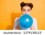 Close up photo of funky childish cheerful lady impressed by size of ballon for festivals carnivals celebration anniversary. Dressed in white cotton outfit isolated over vibrant background