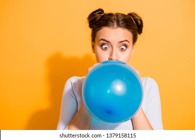 Close up photo of funky childish cheerful lady impressed by size of ballon for festivals carnivals celebration anniversary. Dressed in white cotton outfit isolated over vibrant background
