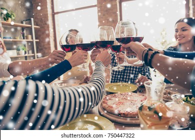 Close Up Photo Of Glasses With Wine. Young People Are Toasting To Celebrate Victory Together, Table Is Full Of Tasty Food And Drinks, Snowflakes Background, Winter Holiday