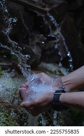 Close up photo of hands being splashed with water.
