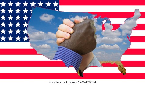 Close Up Photo Of A Handshake Between Afroamerican And European Hands Inside Of US Map Silouette. Handshake Is In Front Of US Flag.