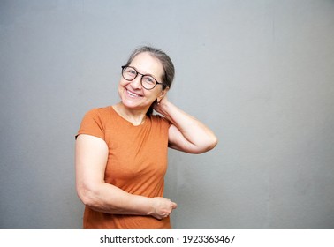 Close up photo headshot of charming attractive satisfied calm neutral granny having straight teeth wearing   isolated grey background