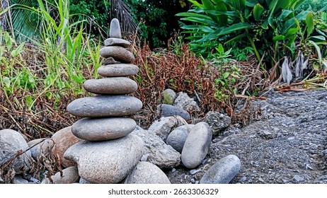 close up photo image of a stack of balancing stones in a forest
