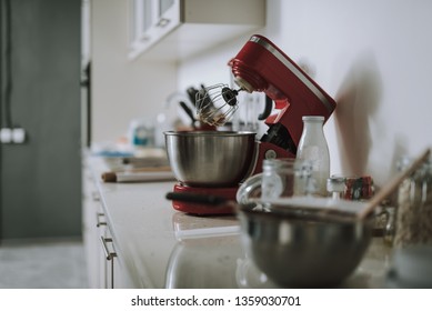 Close Up Photo Of The Kitchen Countertop With No People And Modern Red Electric Stand Mixer With Dirty Whisk