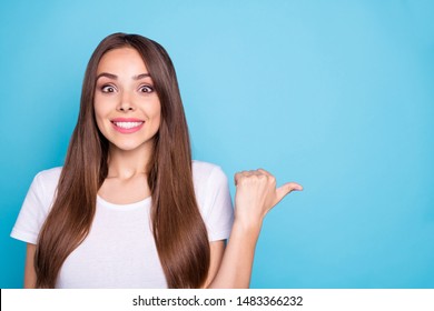 Close up photo of lovely youth showing at copy space having news about bargains isolated over blue background - Shutterstock ID 1483366232
