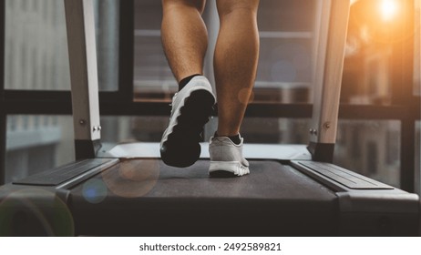 Close up photo of male feet on a treadmill. Cardio. he is running on treadmill in fitness. Man exercising in the gym.