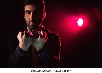 Close Up Photo Of Man Showing Two Fists On Pink And Black Background.