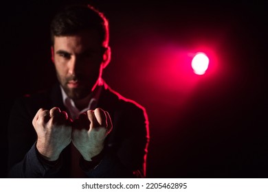 Close Up Photo Of Man Showing Two Fists On Pink And Black Background.