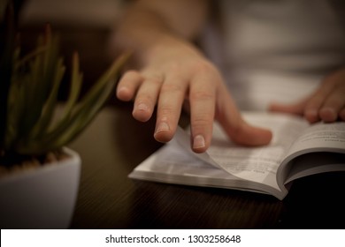 Close up photo of man#s hand holding a book. - Shutterstock ID 1303258648