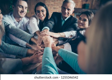 Close up photo many large group of people  glad about progress income earnings development investment showing gesture hands together all dressed in formal wear jackets shirts
