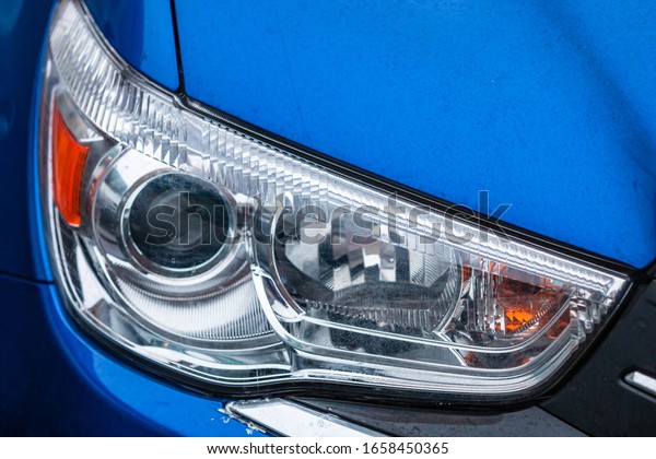 Close up photo of modern car, detail of\
headlight. Headlight car Projector LED of a modern luxury\
technology and auto\
detail.