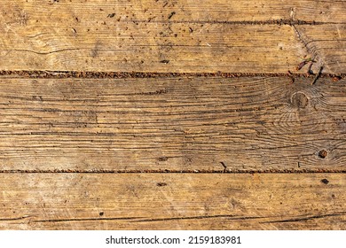 Close up photo of old vertical timber wall. Open air hardwood stage floor. Rough timber background. Old vertical wooden wall. Brown weathered hardwood parquet floor. Aged timber texture background 