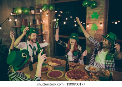 Close Up Photo People Two Couples Green Beverage Hold In Air Hats Leaf Eat Food Pizza Sausage Chips Leprechaun Costumes Checkered Plaid Shirt Rest Relax Together Weekend Vacation Free Time Leisure