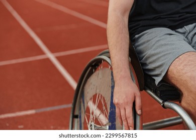 Close up photo of a person with disability in a wheelchair training tirelessly on the track in preparation for the Paralympic Games - Powered by Shutterstock