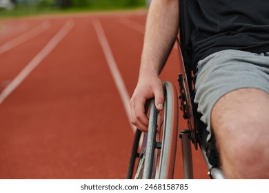 Close up photo of a person with disability in a wheelchair training tirelessly on the track in preparation for the Paralympic Games - Powered by Shutterstock