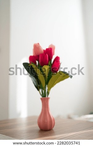 Close up photo of a pink tulips in vase, flower decoration in home.