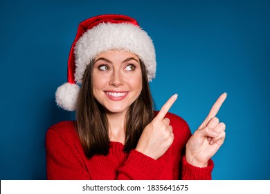 Close up photo positive girl in santa claus hat point index finger, copyspace direct way x-mas christmas newyear ads promotion wear style stylish sweater isolated dark blue color background - Powered by Shutterstock