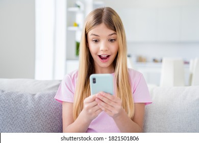 Close Up Photo Of Positive Shocked Girl Kid Study Remote Blogging Use Smartphone Impressed Social Network Comment Post Sit Divan In House Indoors