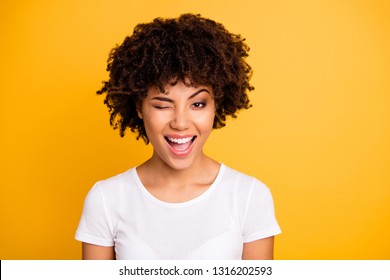 Close up photo pretty amazing she her dark skin lady cool look glad winking one eye mouth open laugh laughter wearing casual white t-shirt isolated yellow bright vibrant vivid background - Shutterstock ID 1316202593