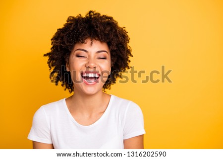 Close up photo pretty amazing she her dark skin lady scream shout of laughing funny joke humor comic story open mouth wearing casual white t-shirt isolated yellow bright vivid background