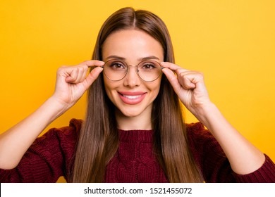 Close up photo of pretty teacher touching her specs wearing maroon sweater isolated over yellow background