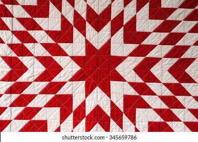 Close Up Photo Of A Red And White Lone Star Quilt, A Traditional American Patchwork Design, Also Known As Texas Star Or Star Of Bethlehem