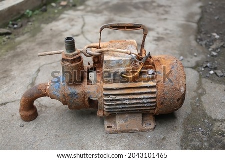 Close up photo of a rusty water pump that has not been used for a long time until it rusts. This photo is suitable for a collection of old items that are not used
