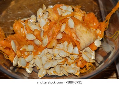 Close Up Photo Of The Seeds And Guts Of A Pumpkin 