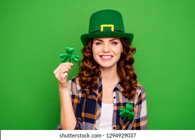 Close up photo of she her brunette hold hand showing leaf as symbol of holiday tradition wearing casual checkered plaid shirt leprechaun headwear isolated green vivid bright vibrant background