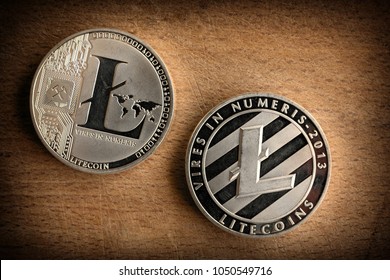 Close up photo  shiny silver litecoins laying on wooden background. Isolated litecoin (ltc).  Detail - Macro photo of new modern decentralized cryptocurrency