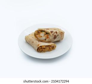 Close up photo of a sliced Chicken Tikka wrap on a white plate in white background