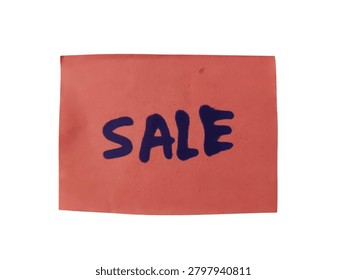 A close up photo of a small red rectangular piece of paper with the word Sale written in black marker, perfect for retail and marketing promotions.