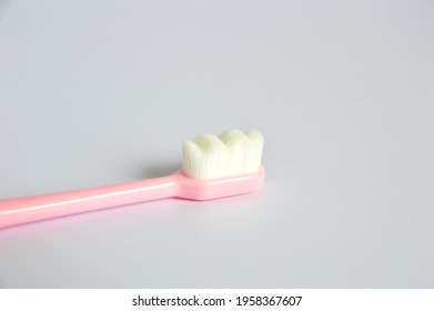 Close up photo of superfine micro-nano Japanese plastic toothbrush in gray background - Powered by Shutterstock